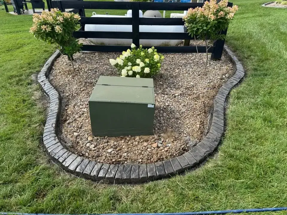 Continuous concrete edging following the curve of a finished bed.