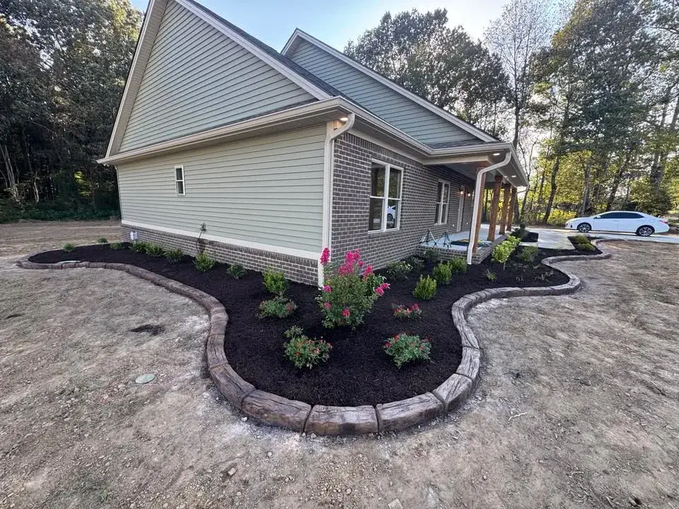 Concrete edging following a garden bed beside a gravel path.