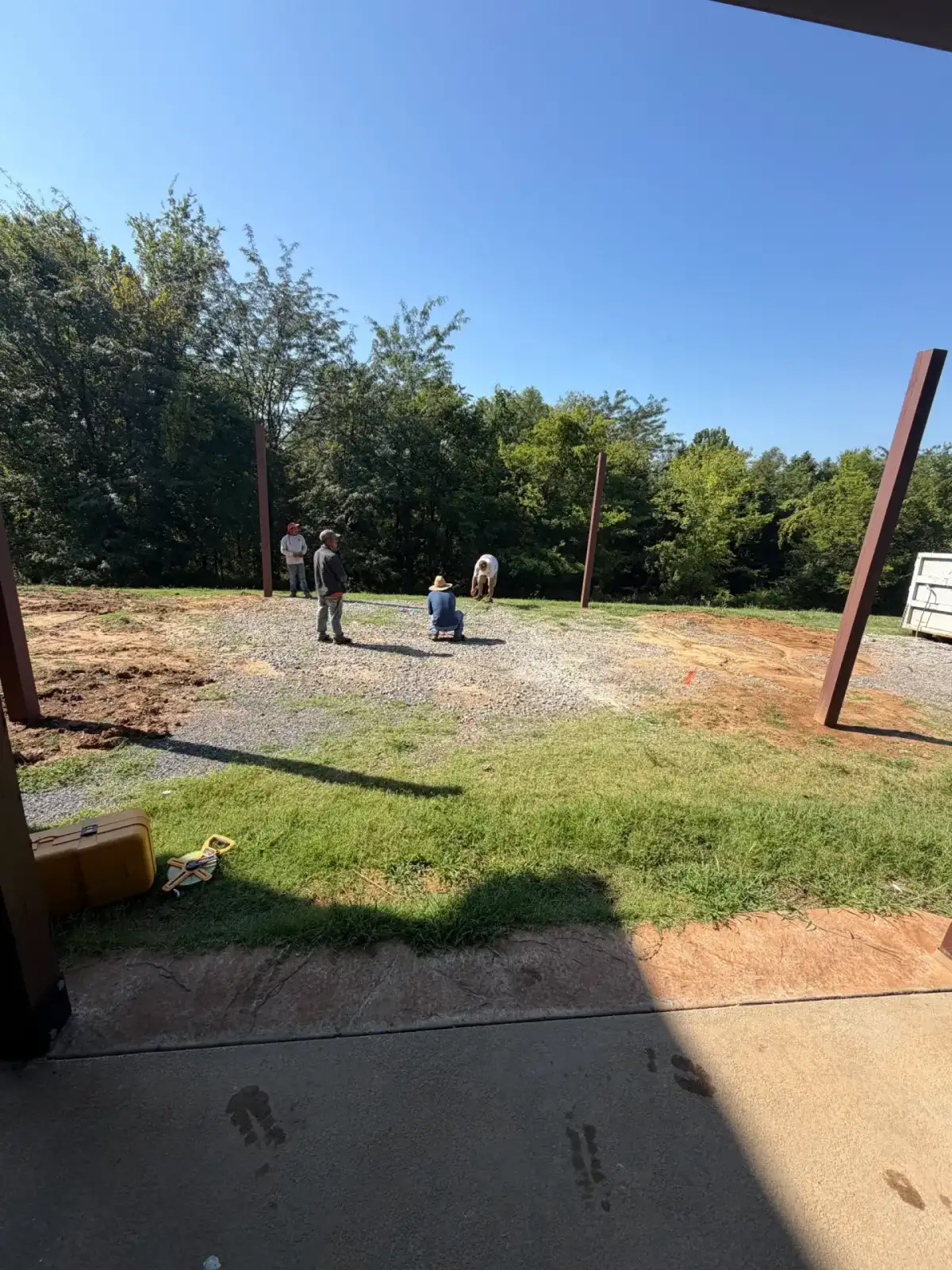 The Muscle crew measuring and grading an outdoor living project
